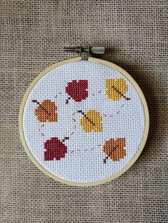 a cross stitch pattern with autumn leaves on it