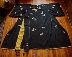 This is the most amazing kimono I have come across in awhile. It is silk, may be a raw silk as not as smooth as like silk satin but am thinking that it is a black silk jacquard with embroidered butterflies. I think you can see the amazing pattern to the silk in some of the pix. It would be pretty impressive itself but with those hand embroidered butterflies which vary both in size, detail, and coloring it is over the top. Unfortunately, the pix make the lining and golden yellow trim look way too Silk Evening Kimono With Kimono Sleeves, Ceremonial Silk Kimono With Kimono Sleeves, Yellow Family, Embroidered Butterflies, Yellow Butterflies, Yellow Trim, Traditional Kimono, Iron On Fabric, Embroidered Butterfly