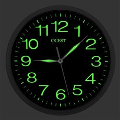 a black clock with green numbers and the words ocst on it's face