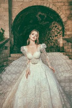 a woman in a wedding dress posing for the camera