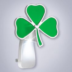 a four leaf clover shaped light fixture on a gray background with room for text or image