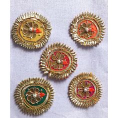 four different types of brooches on a white cloth