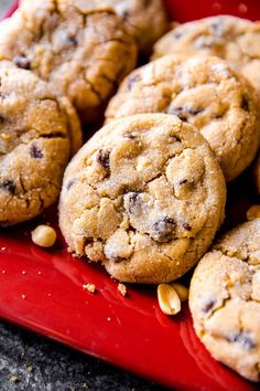 chocolate chip cookies and peanuts on a red plate