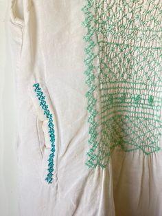 Local Brand White w Green Embroidery Dress. Perfect sleeveless mini dress with delicate green embroidery and back keyhole and button closure. Front pockets with bright teal detail! Flirty and sheer, perfect for a summer day on the town or strolling the pier. Feels like linen. hand wash cold. Marked as XS. Has a faint area of discoloration on the left breast area. Sold as is. Approx. Measurements Underarm to Underarm: 13" Length: 36" Casual Green Embroidered Dress With Embroidered Hem, Green Cotton Embroidered Summer Dress, Casual Green Embroidered Hem Dress, Green Embroidered Cotton Dress For Summer, Casual Green Dress With Embroidered Hem, Green Embroidered Hem Dress For Summer, Green Embroidered Dress With Embroidered Hem For Summer, Green Bohemian Cotton Embroidered Dress, Green Embroidered Dress With Hem Detail For Summer