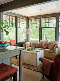 a living room filled with furniture and lots of windows