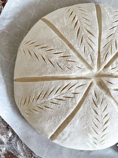 an uncooked pizza sitting on top of a white plate