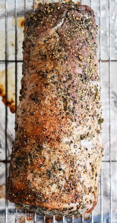 a meatloaf on a cooling rack with seasoning sprinkled over it