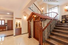 an entry way with stairs and wooden doors