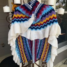 a multicolored sweater hanging on a coat rack