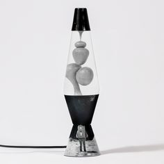 a black and white lamp with rocks in it