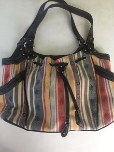 You are purchasing a brand new Caribbean Joe Purse tote bag. 2 side pockets on outside. Inside has one zippered pouch plus 2 pockets. Colorful stripes with palm trees. Brown faux leather handles. No tags but never used. There’s some small white spots on bottom please inspect photos carefully. Nice & clean inside. Bag Measures 15” x 10” x 4” PayPal only. Please remit payment within 3 days of purchase. Please feel free to make any inquiries prior to purchasing. My goal is to provide great service Casual Hobo Bag With Leather Handles, Casual Multicolor Satchel For Errands, Casual Multicolor Canvas Satchel, Casual Multicolor Shoulder Bag With Leather Handles, Casual Satchel For Everyday Use, Multicolor Cotton Shoulder Bag With Leather Handles, Casual Brown Cotton Satchel, Vintage Multicolor Canvas Bag For Everyday Use, Retro Brown Cotton Bag