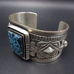 "VINTAGE NAVAJO BRACELET DESCRIPTION: This outstanding cuff is from award winning artisan Jonathan Mike. A stunning specimen of tightly webbed Indian Mountain turquoise is at the center of the handsome cuff. Hand stamped designs and filed accents flank the rectangular gemstone. This exceptional bracelet will be a cherished addition to your collection of fine vintage Native American jewelry. MEASUREMENTS: Interior of the cuff measures 5 7/8\" with an additional 1 3/8\" non-adjustable gap. Total c Antique Handmade Cuff Bracelet, Handmade Antique Cuff Bracelets, Antique Handmade Cuff Jewelry, Adjustable Vintage Sterling Silver Cuff Bracelet, Handmade Antique Cuff Jewelry, Collectible Etched Rectangular Jewelry, Vintage Etched Cuff Bangle, Vintage Collectible Cuff Bangle Bracelet, Vintage Collectible Bangle Cuff Bracelet