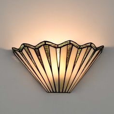 an art deco scallop light fixture on the wall