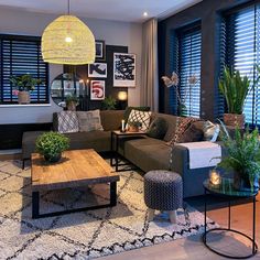 a living room filled with lots of furniture and plants on top of a coffee table