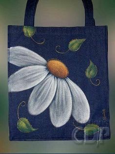 a blue bag with white flowers painted on it