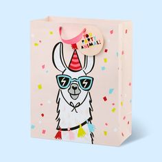 a llama wearing sunglasses and a party hat on top of a pink gift bag