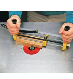 a person is using a machine to cut wood and metal parts on a piece of equipment