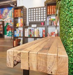 a wooden bench sitting inside of a library