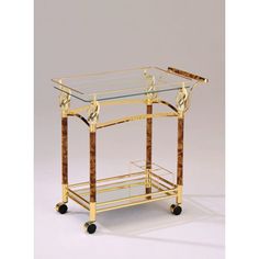 a glass and brass bar cart with wheels