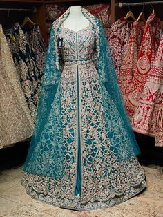 Magnificent turquoise blue decor with beautiful handmade zardosi embroidery with pearl, crystal stone and french knots work in floor length lacha paired with underneath skirt and veil embroidered net dupatta. Enter With Royalty In That Pretty Veil And Give All The Chills! Fabric: Shirt in Net and Lehenga in Raw Silk This lacha can be customized in different colors and specific to client measurements. 120 days delivery time! Eid Fits, Indian Bridal Wear Red, Sewing Corner, Checked Shirt Dress, Zardosi Embroidery, Desi Wedding Dresses, Wedding Lehenga Designs, Gold Crystals, Pakistani Fancy Dresses