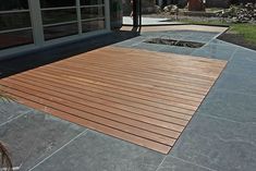 a wooden deck in front of a building