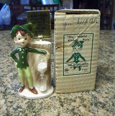 a little elf figurine next to a box