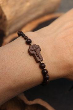 +.This is a rosary bracelet made of wood. The crucifix and the beads are constructed of wood. +.The wooden rosary is beneficial because you can feel the softness of the wood while praying. The more you contact wood, the more it takes on a natural brilliance. +.Surinamese ebony was used to make the crucifix. The light brown tone of Surinamese ebony is appealing. Surinamese ebony is so hard that it may be carved finely. It is carved over a long period of time rather than molded for a few minutes. Wooden Rosary, Brown Tone, Rosary Bracelet, Confirmation Gifts, Made Of Wood, Rosary, Jewelry Ideas, Christening, Bracelet Making