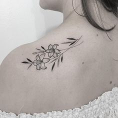 a woman with a flower tattoo on her shoulder