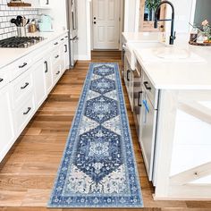 a blue runner rug in the middle of a kitchen