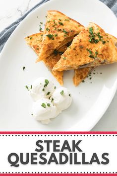 steak quesadillas on a white plate with sour cream