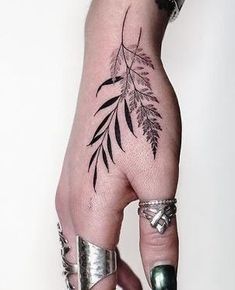 a woman's hand with tattoos on it