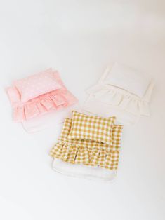 three pieces of cloth sitting next to each other on a white surface with polka dots