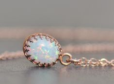 "A sweet new necklace using 14K rose gold and opal. The opal is oval shaped and white in color. It has broad rainbow flashes and excellent fire. Opal is hand set into a premium, rose gold plated crown setting. It hangs from 14K rose gold filled chain, in your length of choice. Opal measures 10mm tall (just under 1/2\") while entire pendant measures 3/8\" long. Please choose desired chain length at checkout. Please see all of my rose gold opal pieces here: https://www.etsy.com/shop/hangingbyathre Opal Pendant Necklace, Necklace Rose Gold, Rose Gold White, Necklace Rose, October Birthstone, Necklace Dainty, Opal Pendants, Opal Necklace, Rose Gold Necklace