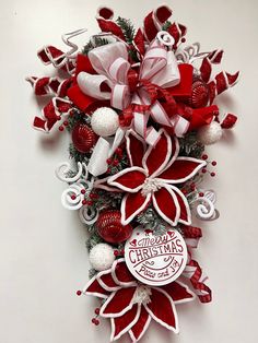 a red and white christmas ornament hanging on a wall