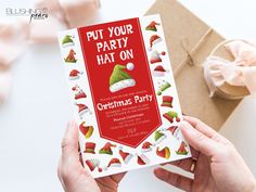 a person holding up a christmas party card