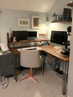 a home office with two computer monitors and a desk