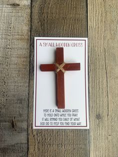 a small wooden cross on top of a card