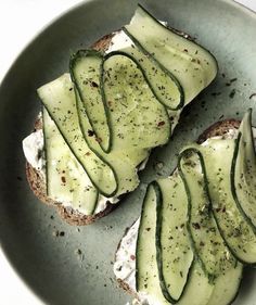 an open face sandwich with cucumber slices on it