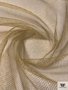 gold mesh fabric with small dots on the top and bottom, as well as an image of