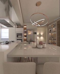 a modern kitchen with white counter tops and chairs