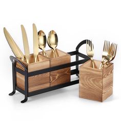 a set of knives, forks and spoons in a wooden holder