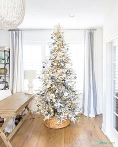 a white christmas tree in a living room