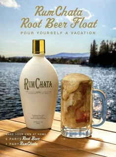 a bottle of rumchata next to a glass on a wooden table near the water