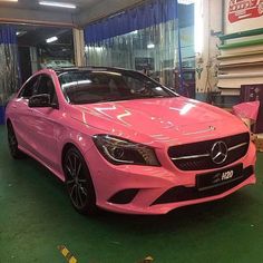 a pink mercedes cla parked in a garage