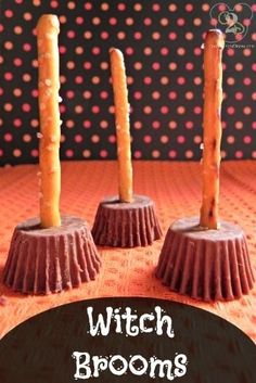 three chocolate covered candy cups sitting on top of a table with candles in the middle