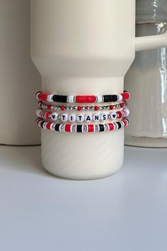 Personalized collection of Red and Black beaded bracelets hand crafted to add personal style to your Stanley cup.  🌟 Great for gift giving, holidays, sports, parties, and everyday charm. 🌟 Set includes 4 bracelets designed to fit the 40oz Stanley Quencher with a silicone boot in place.  🌟 Add your own Personalization to this set. Letters, Numbers, and Hearts only. Recommend 10 characters or less for visibility. Spaces will be filled with a small, silver, circular bead.  🌟 Message me if you would like to create a similar set with different colors.  Tips & Care: - Will also fit the 20oz and 30oz Stanley cups with a silicone boot (not included) - Remove bracelets prior to washing tumbler. Not dishwasher safe. - Given the nature of elastic, stretching or breakage may occur overtime. Take c Casual Black Beaded Bracelets For Valentine's Day, Black Beaded Bracelets With Letter Beads For Valentine's Day, Red Letter Beads Bracelet For Gifts, Black Beaded Bracelet With Letter Beads For Valentine's Day, Red Beaded Bracelets With Letter Beads As Gift, Red Beaded Bracelet With Letter Beads As Gift, Customized Red Beaded Bracelets As Gift, Customized Red Beaded Bracelet For Gift, Customized Red Casual Jewelry