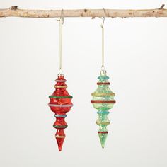 three glass ornaments hanging from a tree branch