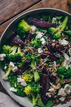 a salad with broccoli, beets and feta cheese in a bowl