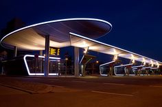 an empty gas station lit up at night