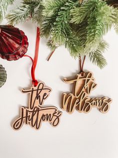 two wooden ornaments hanging from a christmas tree